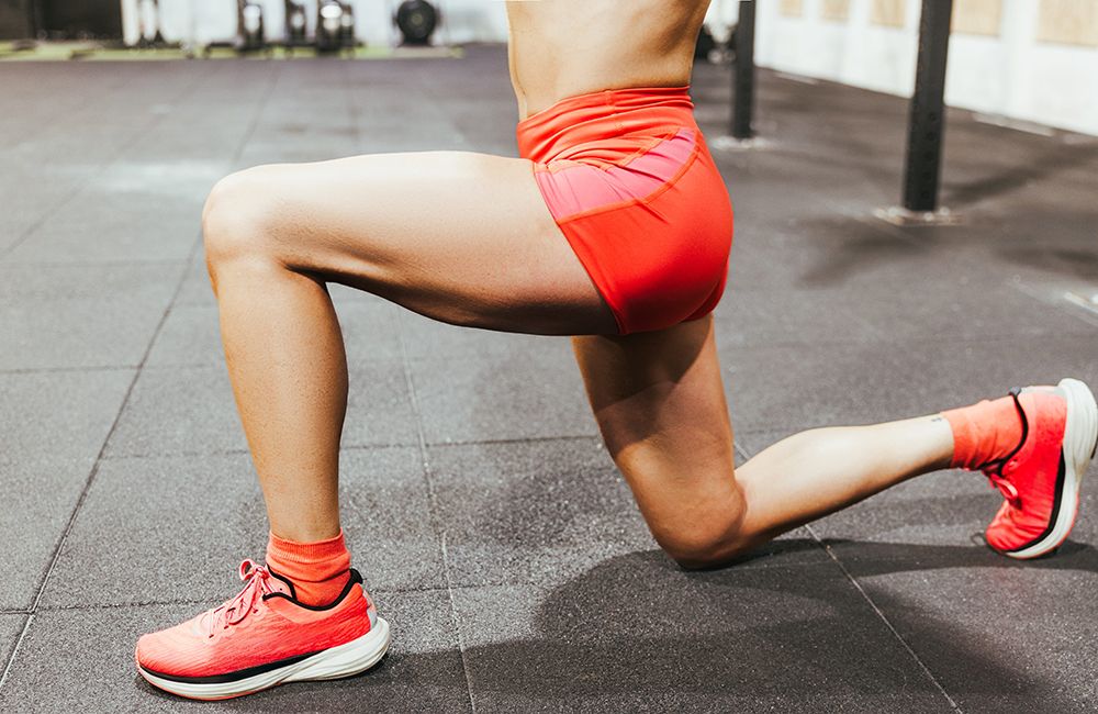 Detail view of strong woman legs during strength training at box gym