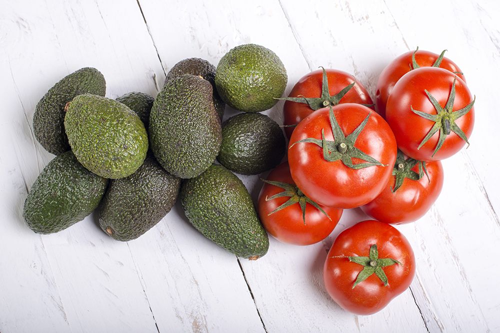 Tomatoes with lawyers on eves white wooden plank